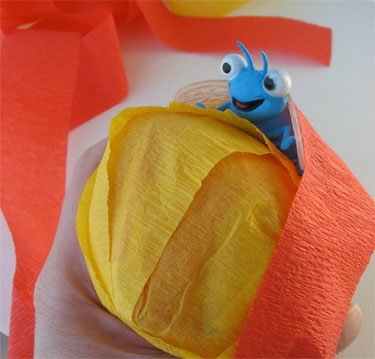 Plastic toy inside crepe paper ball 