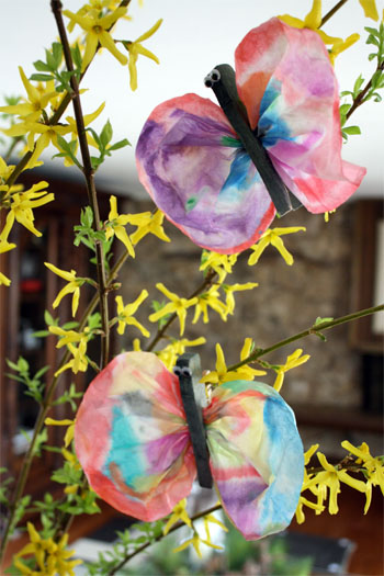 paper butterfly crafts hanging in a tree 
