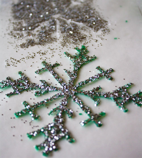 Glitter sprinkled on plastic snowflake 