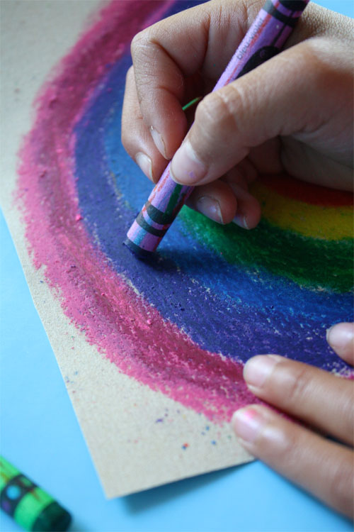 rainbow being colored onto sandpaper 