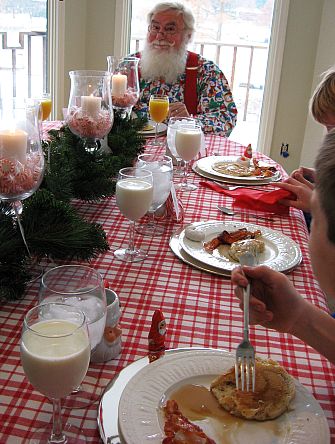 Breakfast with Santa. Santa is sitting at the head of a well decorated table with fine china and boys. -Skip To My Lou
