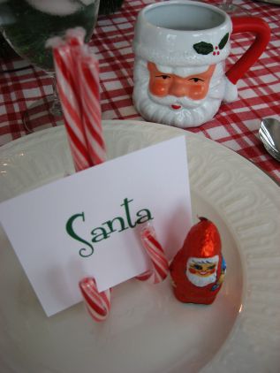 Breakfast with Santa table setting with Santa mug and boys nametag on candy canes on top of white china plate.  -Skip  To My Lou