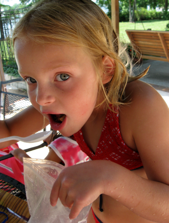child eating ice cream in a bag