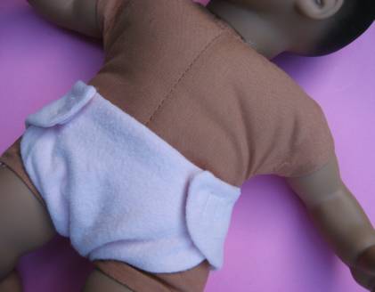 baby doll wearing cloth diaper make from free doll diaper pattern
