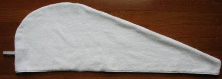A completed towel wrap turned right side out with elastic loop at the bottom