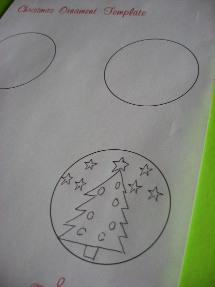 Template for inside glass ornament. A child has drawn a Christmas tree with ornaments and stars.