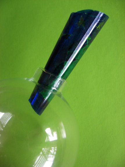 Completed circle rolled up being slide into the glass ornament.