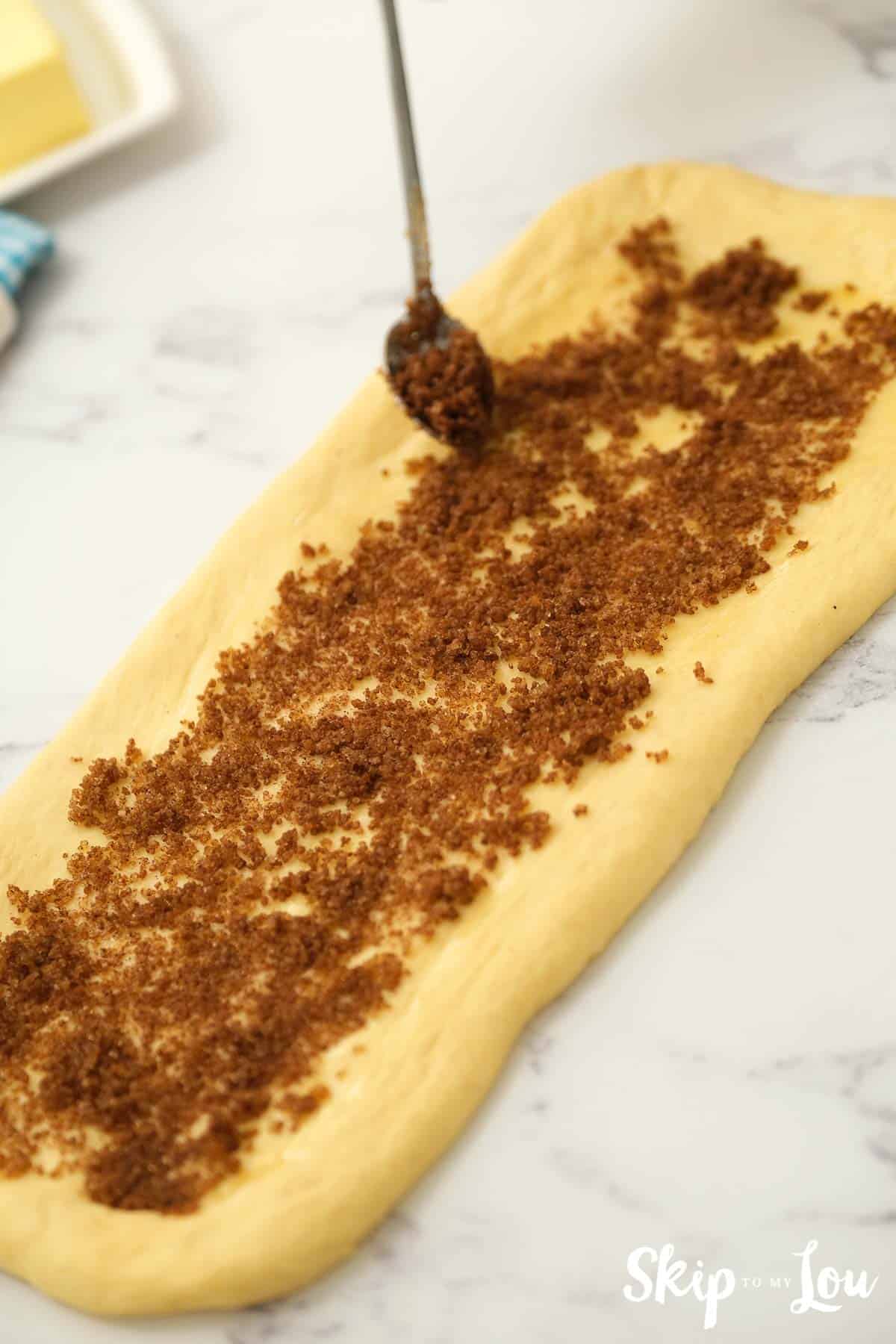 King Cake rolled into rectangles and sprinkled with cinnamon-sugar filling