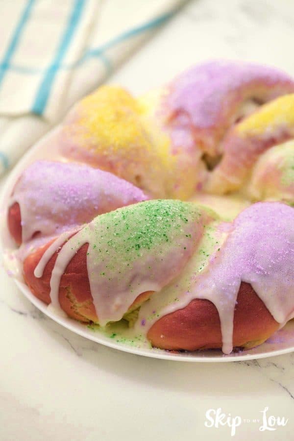 mardi gras king cake on white platter