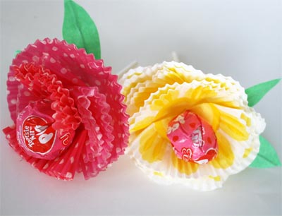 Red and yellow muffin paper flowers with red tootsie pop centers and stems