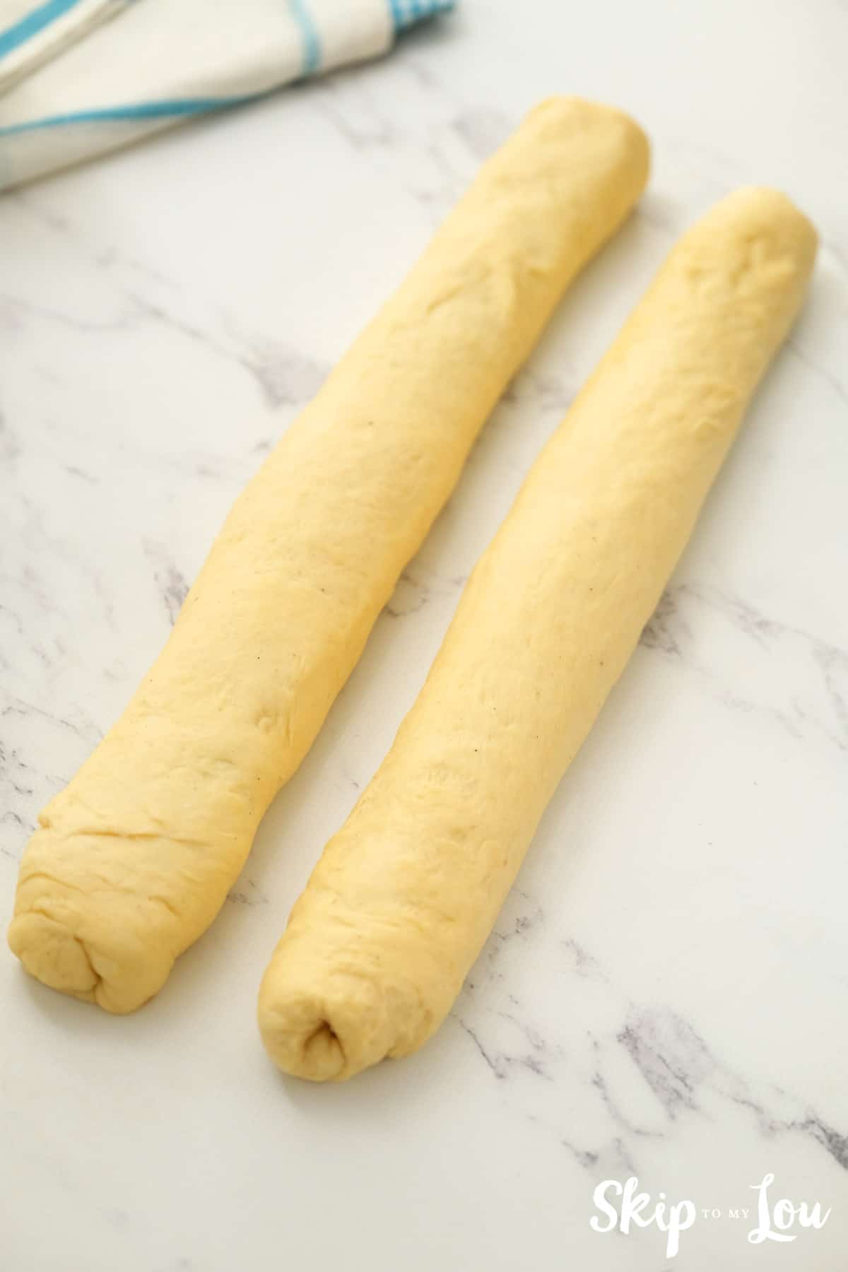 King Cake dough rectangles rolled together with filling