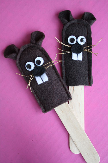 two groundhog puppets on popsicle sticks