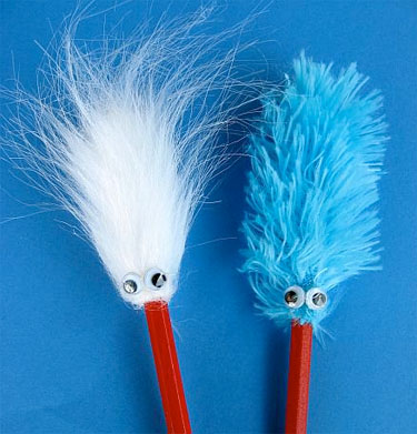 a white 'thing' pencil topper and a blue 'thing' pencil topper both have wiggly eyes and are on pencils painted red just like 'Thing 1 and Thing 2' wear