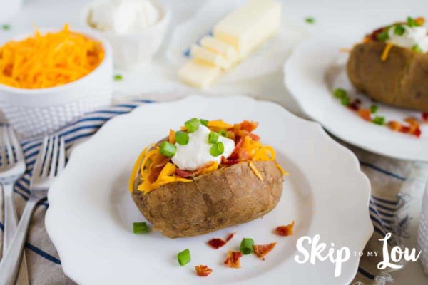 slow cooker baked potatoes with all the toppings on a plate