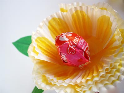cute flower make from baking cup with tootsie roll pop in center