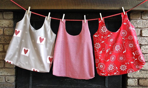 three reusable shopping bags hanging
