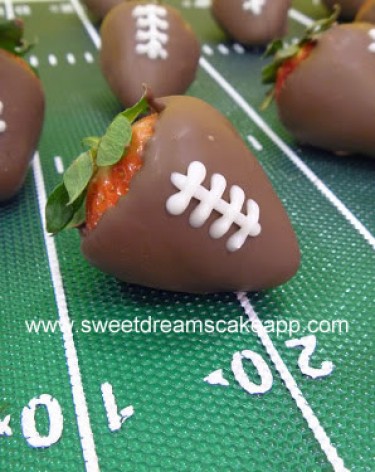 strawberry dipped in chocolate with white detail looks like football