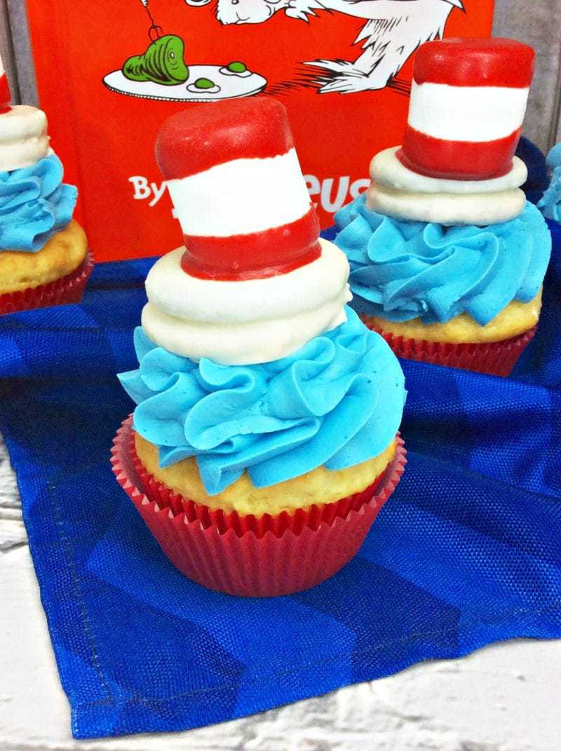 cat in the hat cupcakes marshmallow dipped in red and white candy coating on top a white dipped oreo