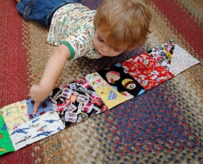 child laying out book