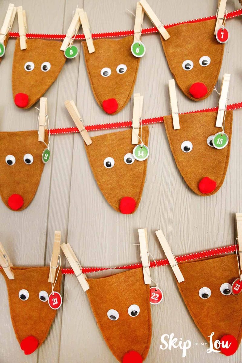 A set of reindeer stocking crafts hanging from the wall