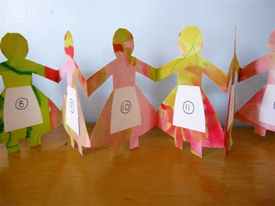 Paper doll advent calendar on top of a table