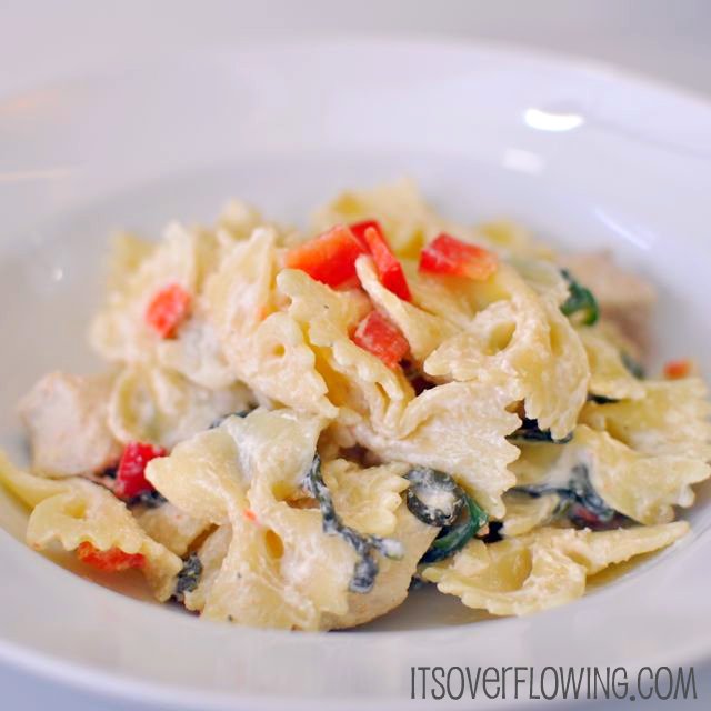 18918001972 Creamy chicken Florentine served in a white pasta bowl.