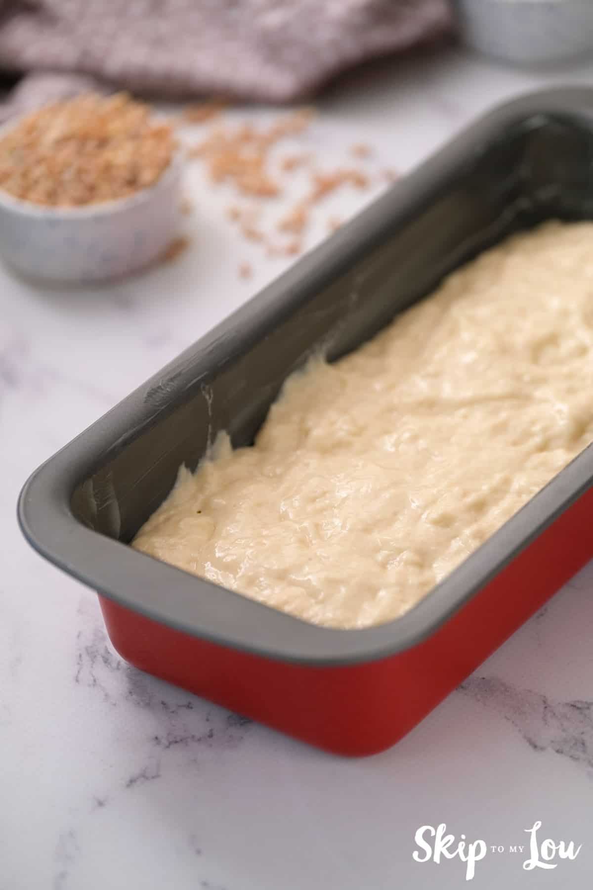 poor prepared batter for beer bread into loaf pan