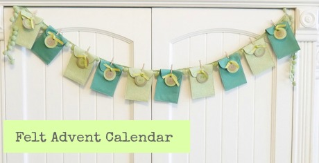 Felt Advent Calendar strung across a doorway with the felt pockets clipped to a ribbon with pom poms in between. The dates are tied to the pockets with a ribbon. -Skip To My Lou