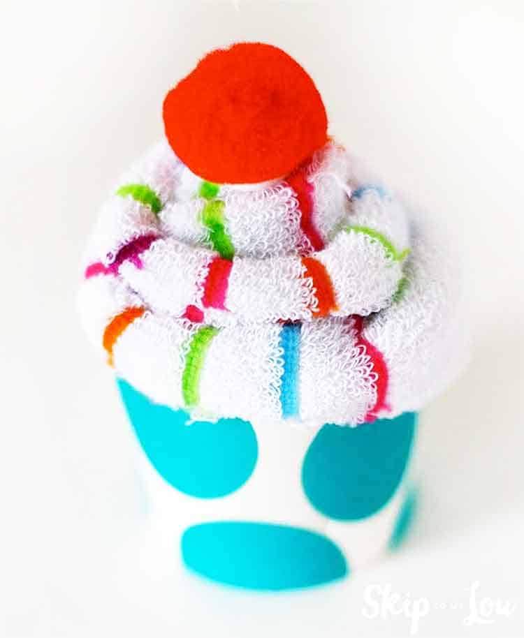 sock cupcake with red pom pom cherry
