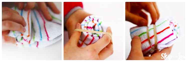 hands rolling up sock and fastening with a rubber band