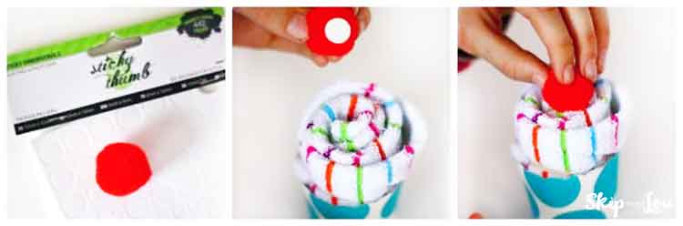 attaching pom to top of sock cupcake with glue dot