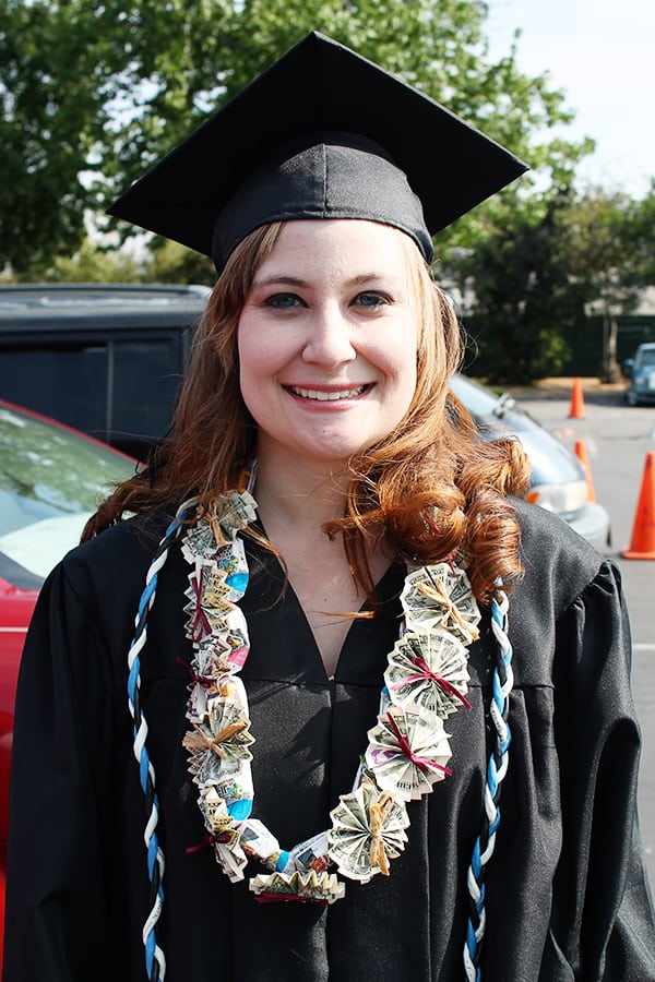 girl grad wearing money necklace