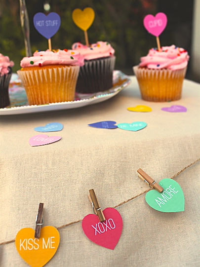 hearts attached to string with clothes pins to make heart bunting around a table