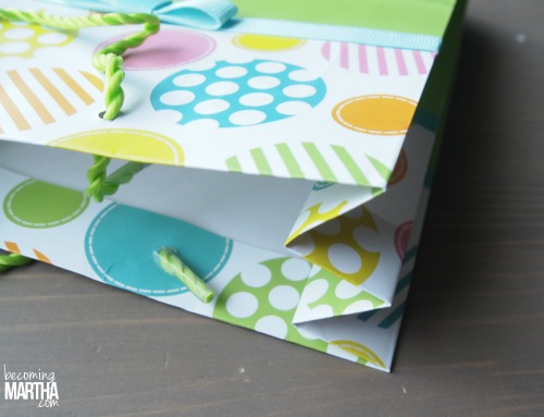 The cut gift bag is folded creating a spine in the middle section of three folds.