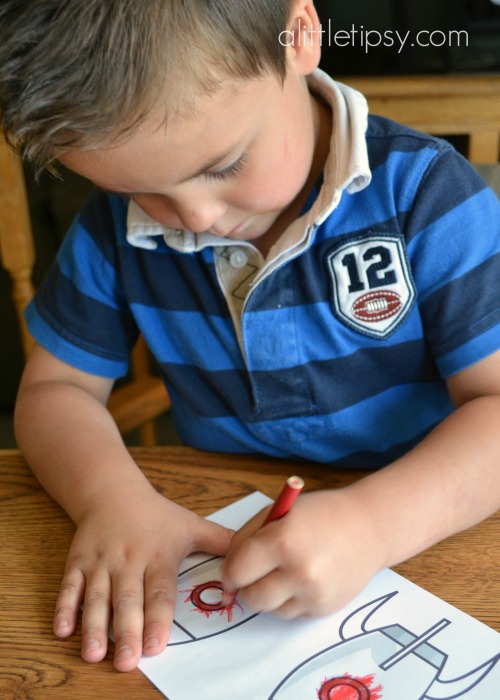 boy coloring rocket