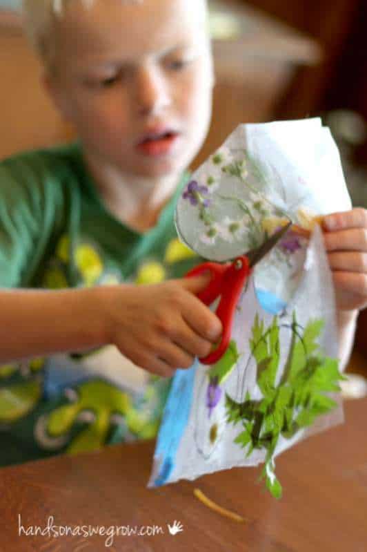 child cutting sun catcher