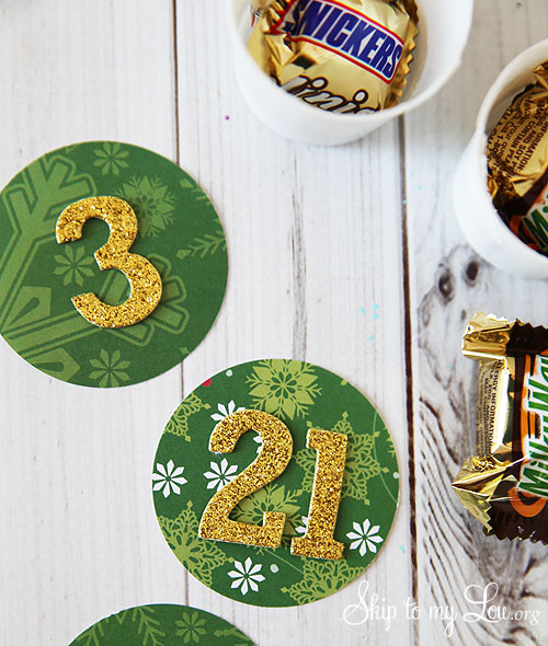 recycled advent calendar numbers on top of the punched tops for the cups. K-cups on the side for the the recycled advent calendar.
