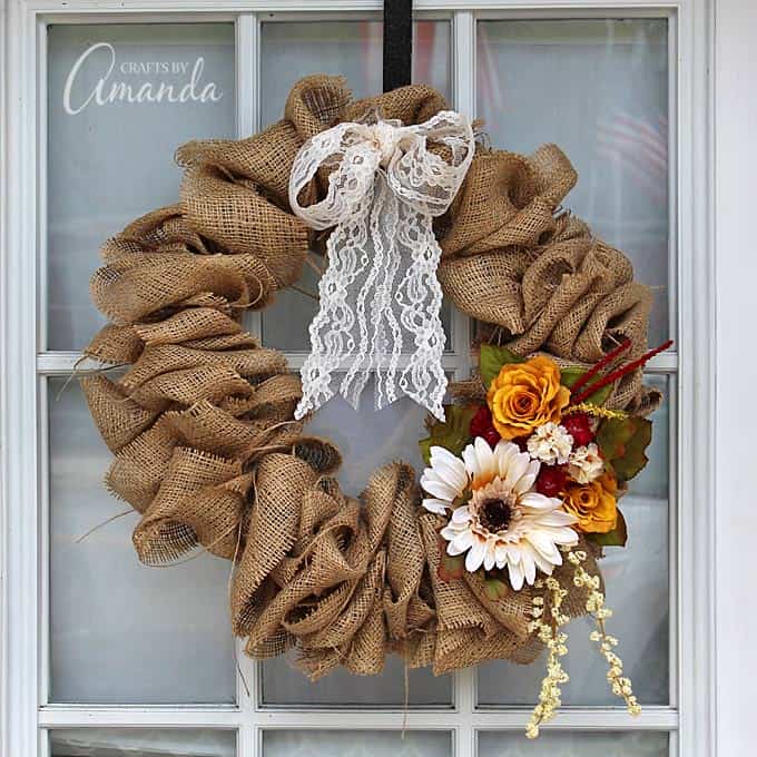 fall burlap wreath with lace and flowers on glass paned door
