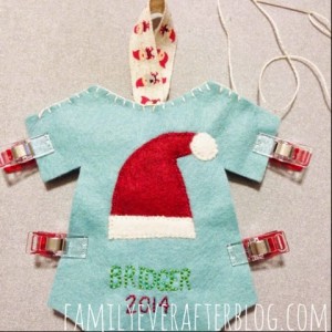 Front and back of ornament (blue onesie) clipped together and whip stitch has been started to sew them together.