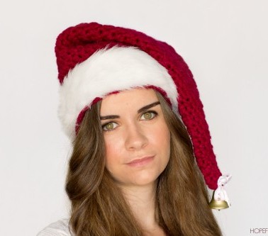 crochet santa hat on a woman with white background skip to my lou
