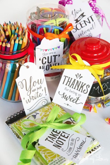 printable teacher appreciation gift tags attached to containers of pencils, scissors, candy and a note pad