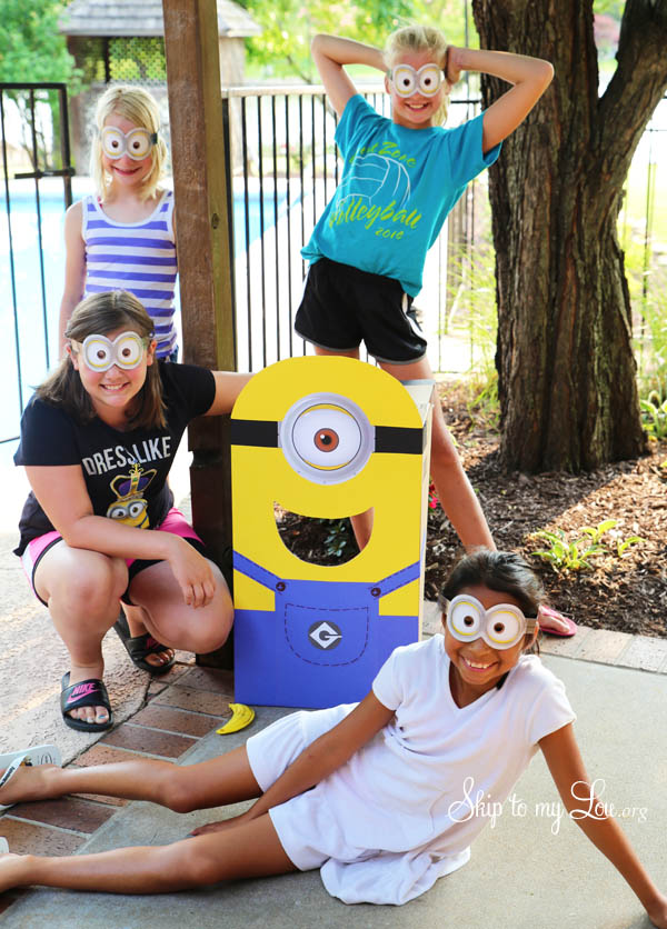minion party toss game with 3 girls wearing minion eye masks on porch at minion party.