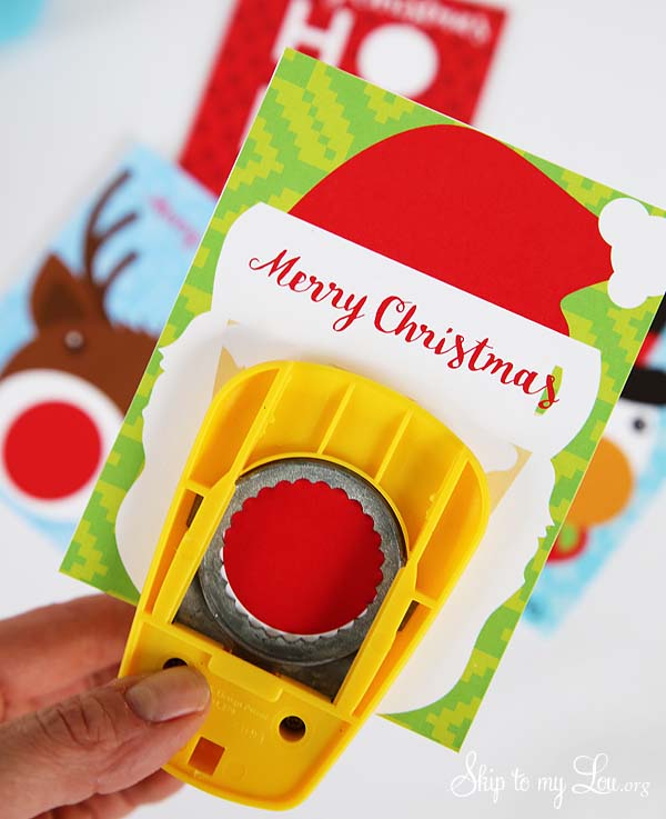 Close up  of EOS Lip balm Santa printable with hole being punched. -Skip To My Lou