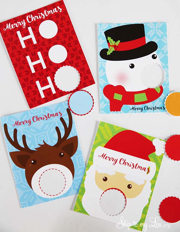 Four EOS Lip Balm Christmas Gifts pintables. A Ho, Ho, Ho , snowman, reindeer, and Santa card. The holes have been punched for the lip balm to be inserted. -Skip To My Lou
