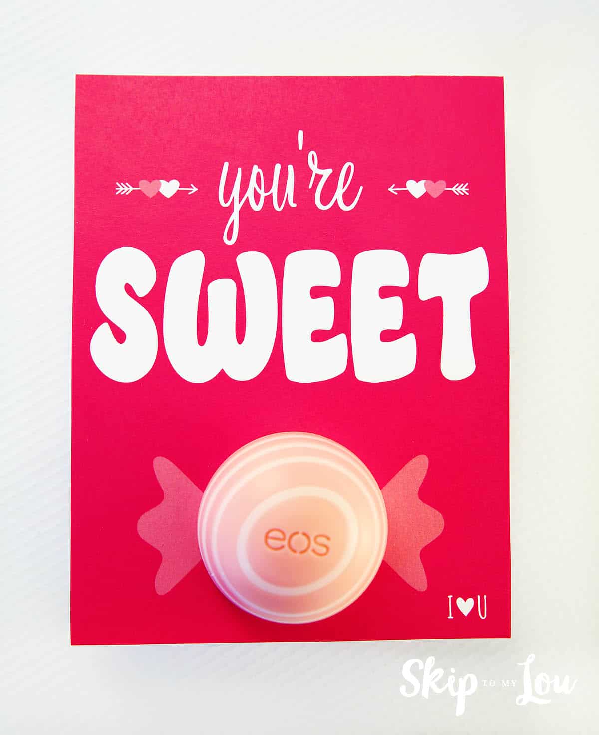 EOS lip-Balm-You're-Sweet-Printable on red paper with the lip balm as the center of a piece of candy.
