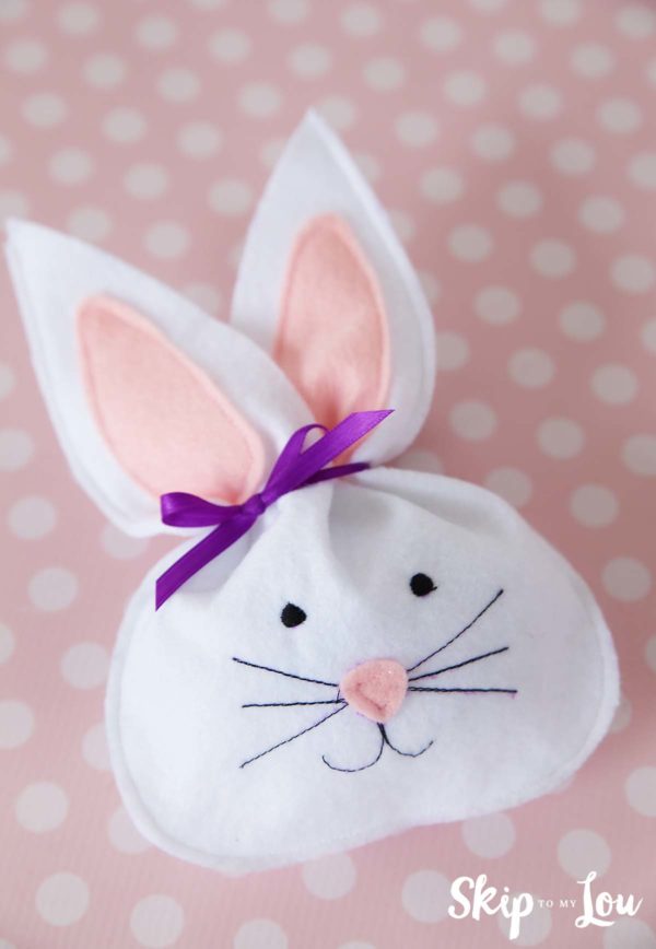 white felt bunny treat bag laying on a pink polka dot table covering