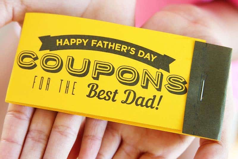 happy father's day coupons for the best dad coupon book held in the palms of two hands