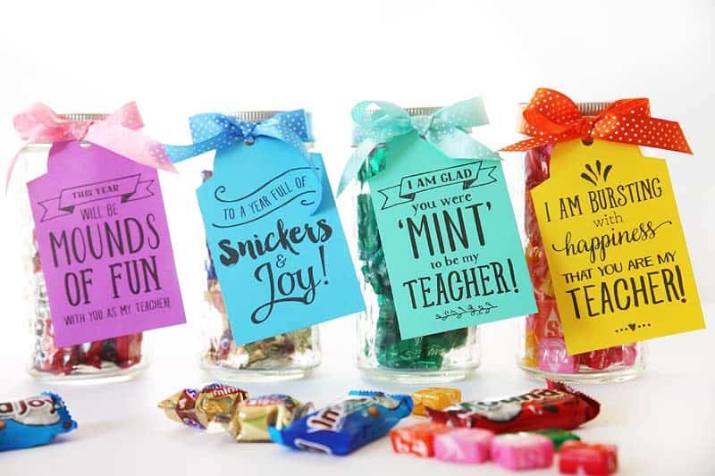 purple, blue, green, and yellow teacher gift tags on jars of candy