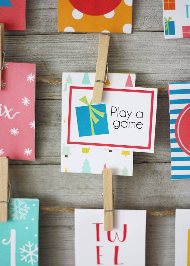 Activity card insert and envelopes attached to a wood back ground with twine and mini clothes pins card displayed says Play a game