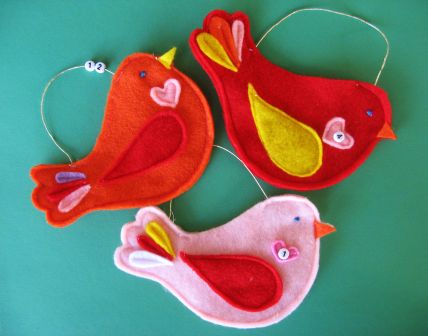 Little Birdie felt advent calendar. Birds are cut from different colors of felt attached with string and uses beaded numbers.
